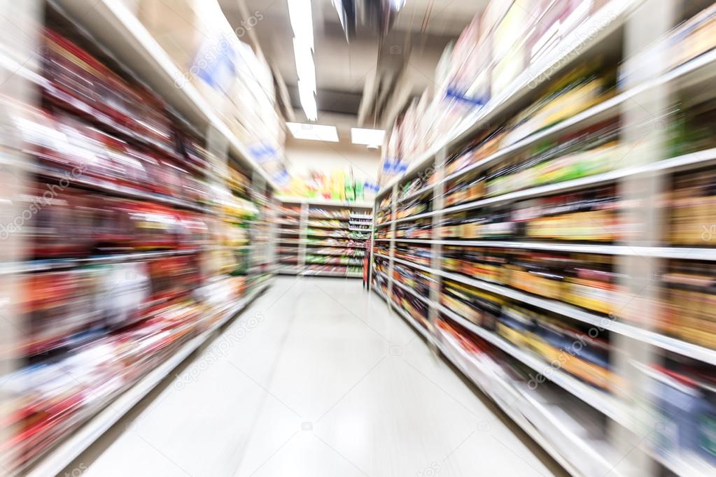 Young woman shopping in the supermarket,motion blur