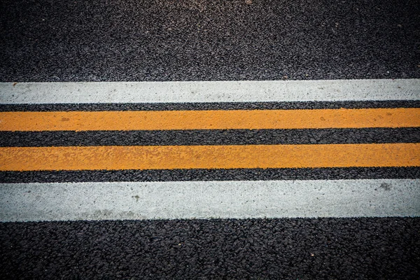 Road texture with white and yellow stripes — Stock Photo, Image