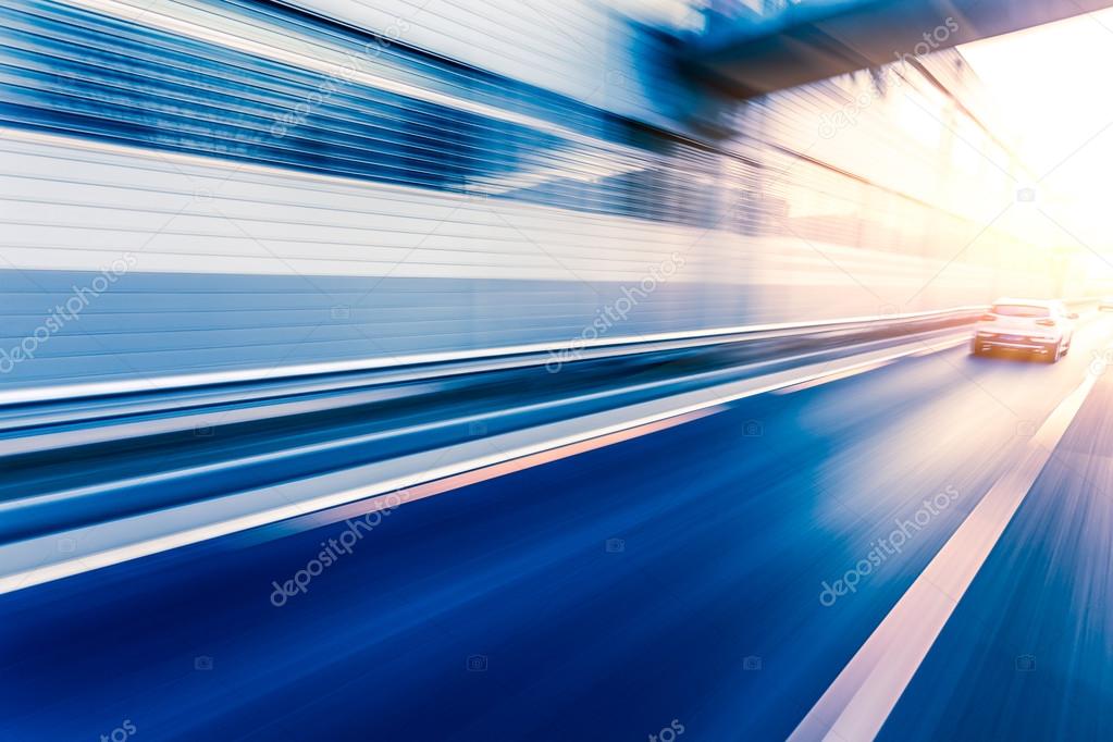 Car driving on freeway at sunset, motion blur 