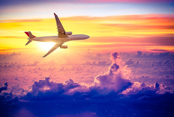 Airplane in the sky at sunrise