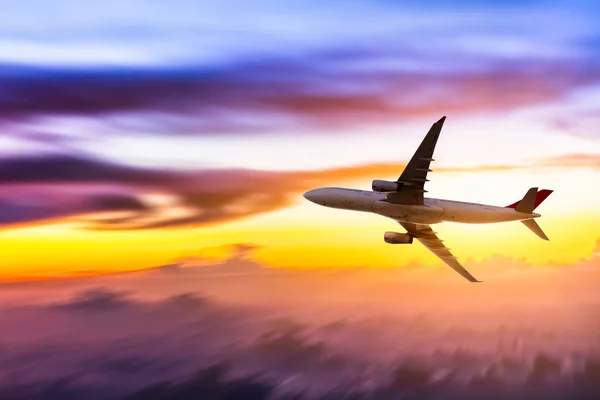 Airplane in the sky at sunrise — Stock Photo, Image