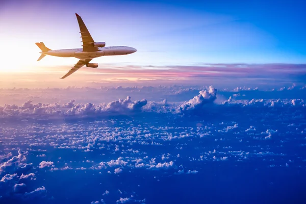 Flugzeug am Himmel bei Sonnenaufgang — Stockfoto