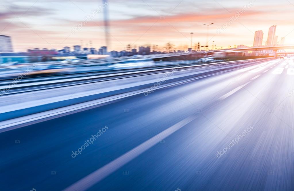 Car driving on freeway at sunset, motion blur