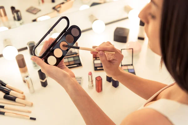 Smuk pige laver makeup - Stock-foto