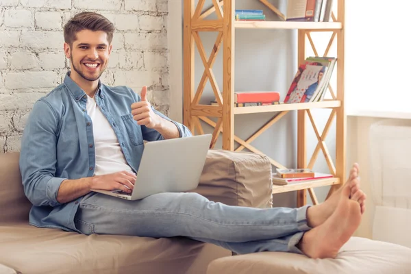 Young man with gadget at home — Stock Photo, Image