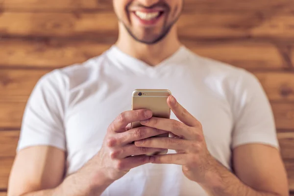 Handsome young man with gadget — Stock Photo, Image