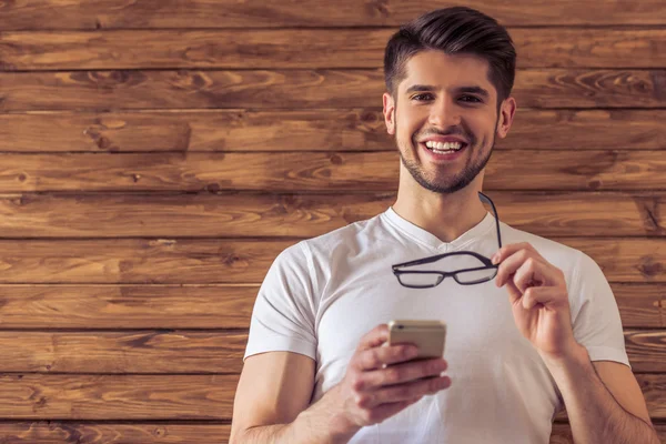 Handsome young man with gadget — Stock Photo, Image