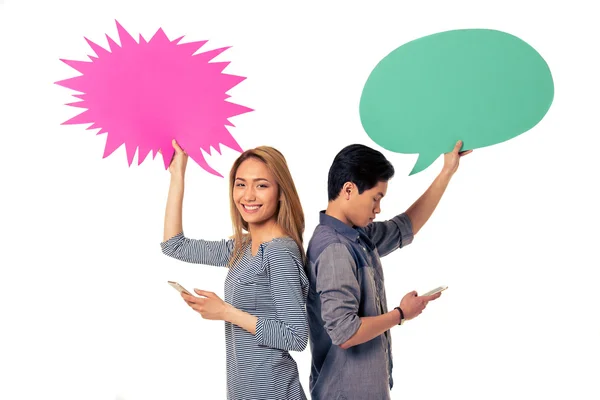Couple with speech bubbles and gadgets — Stock Photo, Image
