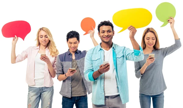 Students with speech bubbles and gadgets — Stock Photo, Image