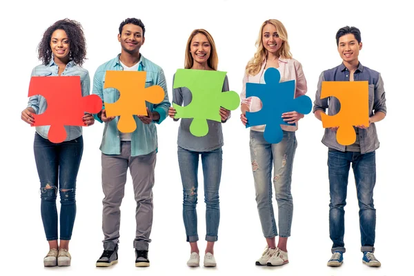Young people with puzzles — Stockfoto