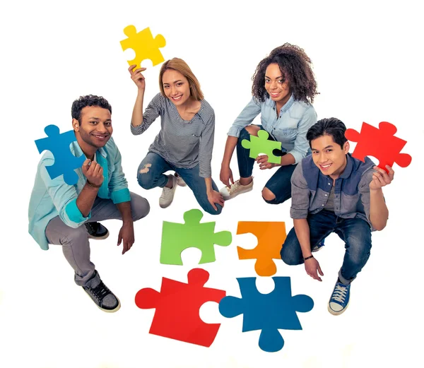 Young people with puzzles — Stok fotoğraf