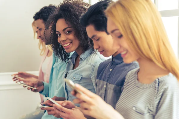 Young people with gadgets — Stock Photo, Image