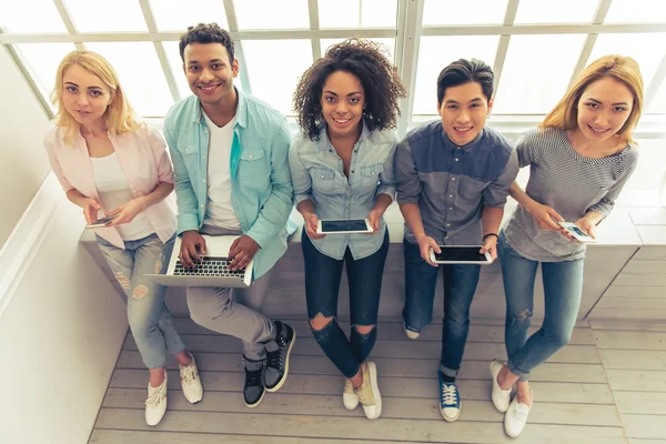 Young people with gadgets — Stock Photo, Image