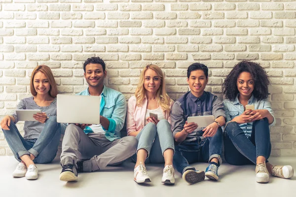 Young people with gadgets — Stock Photo, Image