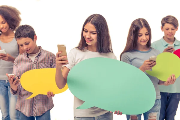 Teenagers with speech bubbles — Stock Photo, Image