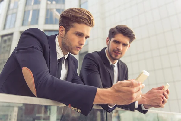 Handsome young businessmen with gadget — Stock Photo, Image