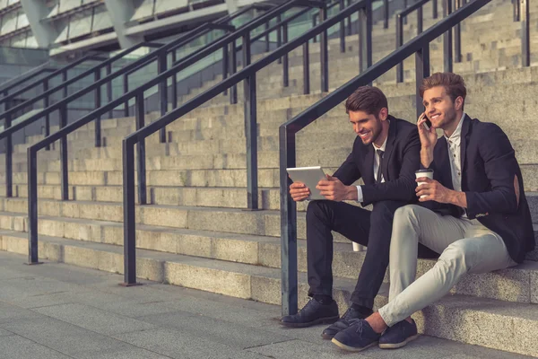 Handsome young businessmen with gadget — Stock Photo, Image