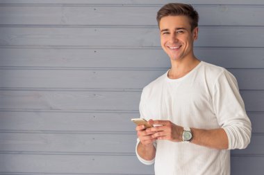 Handsome young man with gadget