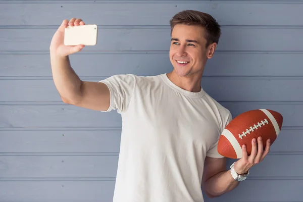 Handsome young man with gadget — Stock Photo, Image