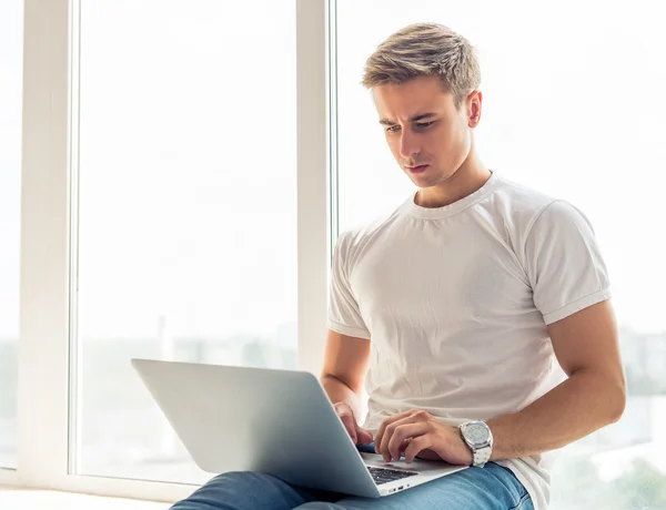 Handsome young man with gadget — Stockfoto