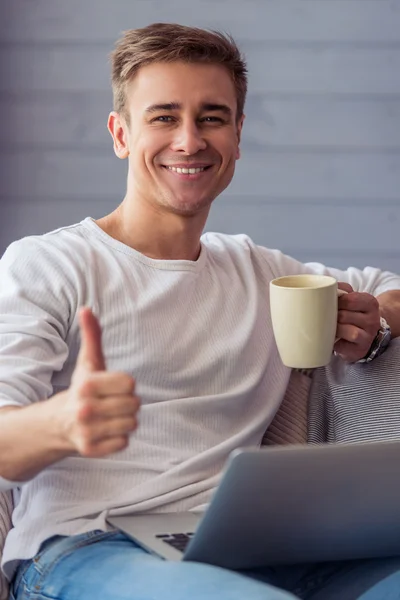 Handsome young man with gadget — Stockfoto