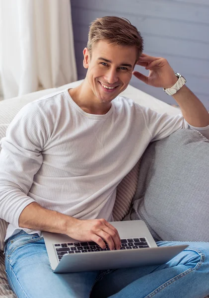 Handsome young man with gadget — Stockfoto