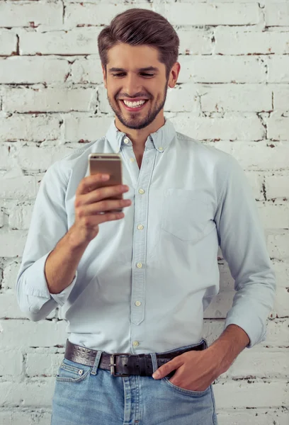 Handsome young businessman with gadget — Stock Photo, Image