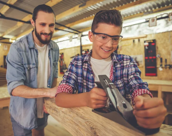 Father and son working with wood