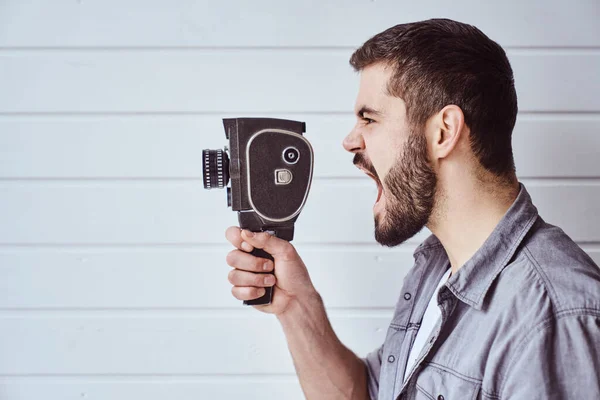 Young Emotional Man While Shooting Old Camera Light Background — Stock Photo, Image