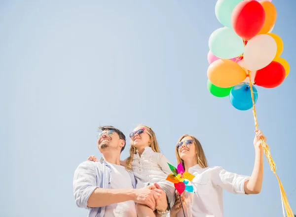 Familia con globos afuera — Foto de Stock