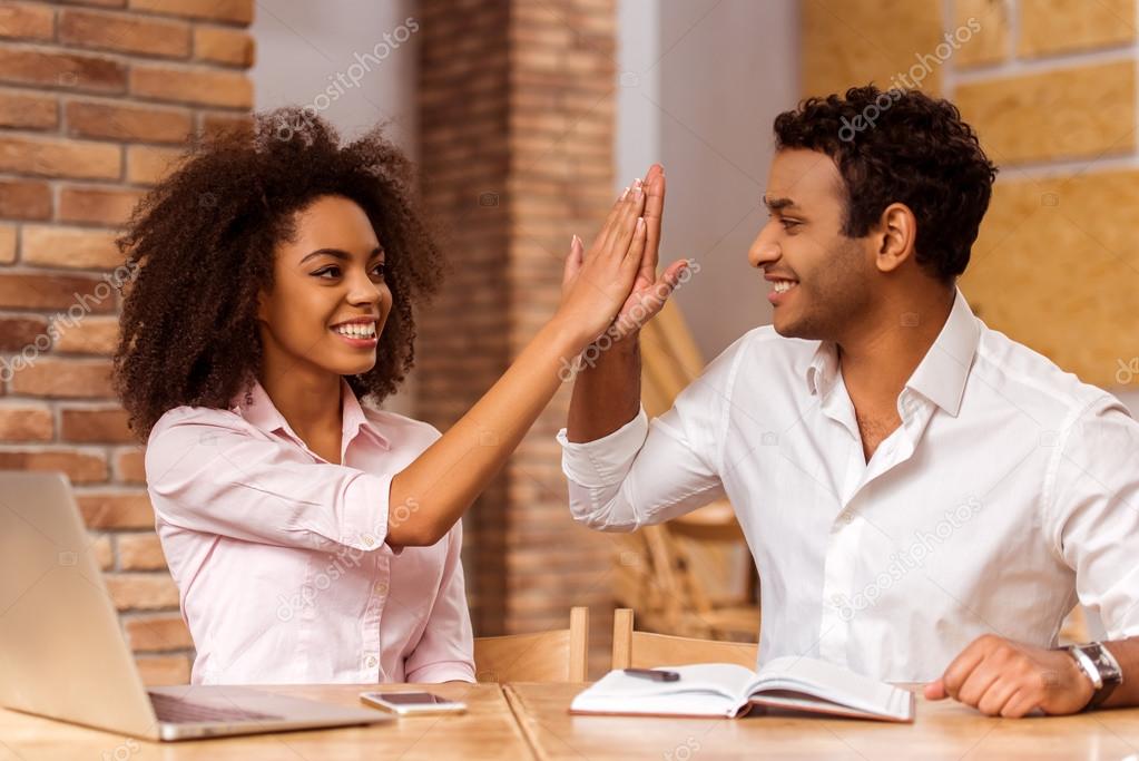 Attractive Afro-American couple working