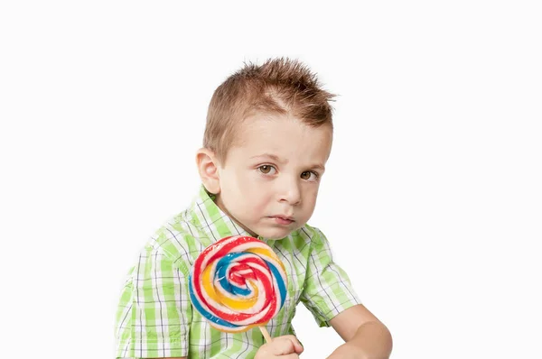 Pensive little boy con lollipop — Stock Photo, Image