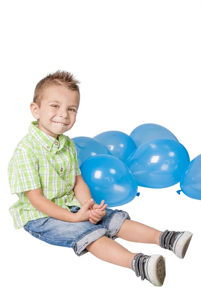 Smiley little boy with blue balloons — Stock Photo, Image