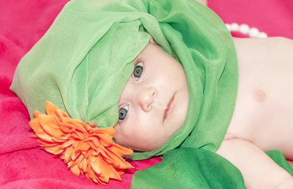 Little smiley baby girl on red blanket — Stock Photo, Image