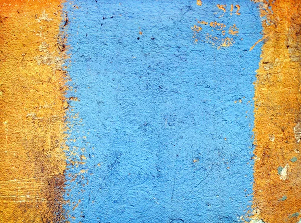 Texture di intonaco giallo con una striscia blu . Fotografia Stock