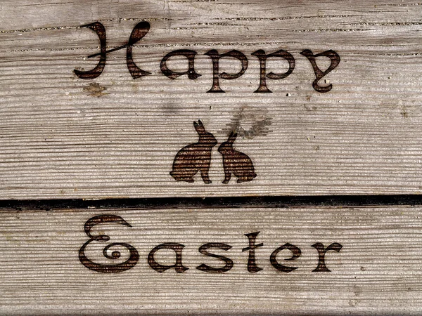 Happy Easter - burned an inscription on a wood. — Stock Photo, Image