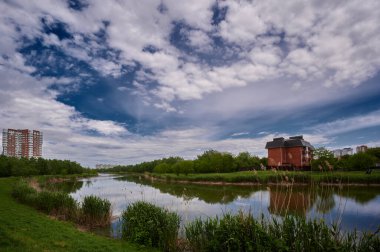 05/19/2021 Lake Karasun against the background of the blue sky and houses of the KMR Krasnodar Russia horizontal photo during the day