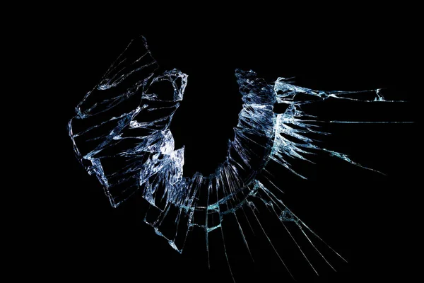 broken mirror and glass from impact on a black background in cracks in the form of an isolated abstraction