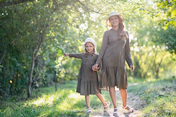 mom and daughter for a walk, in nature