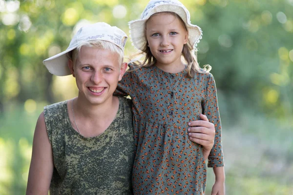 Brother and sister portrait, six years old and eighteen years old