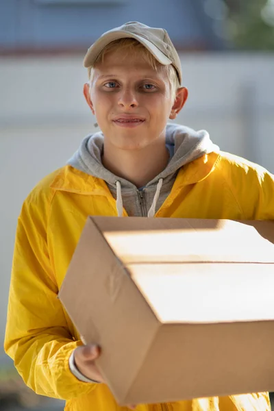 The courier delivered the parcel, the young guy works as the courier brought the goods