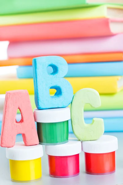 letters abc and stack of books