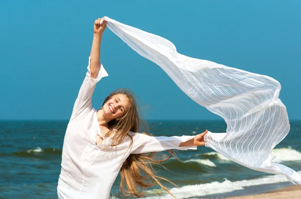 Beautiful girl with white scarf on a beach — Stock Photo, Image