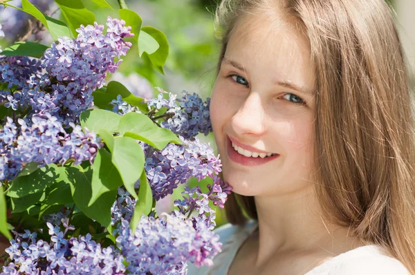 Beautiful girl with a lilac flowers — Stock Photo, Image