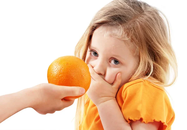 The whimsical child doesn't want to eat orange — Stock Photo, Image