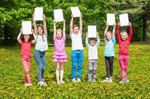 Happy children with white banner — Stock Photo, Image
