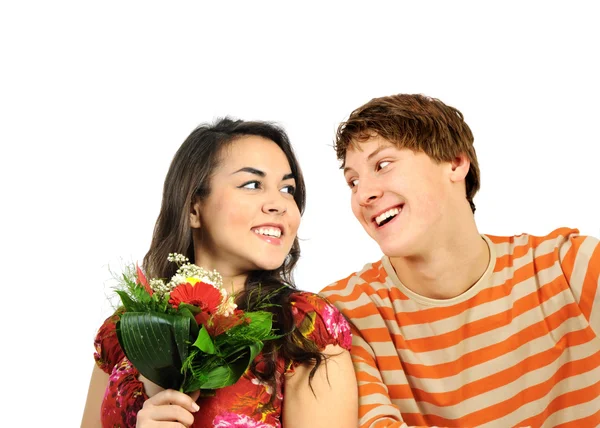 Happy young couple with flowers — Stock Photo, Image
