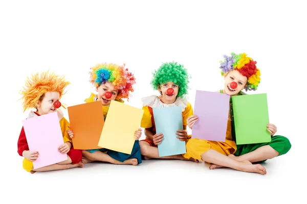 Kids holding colorful blank sheets — Stock Photo, Image