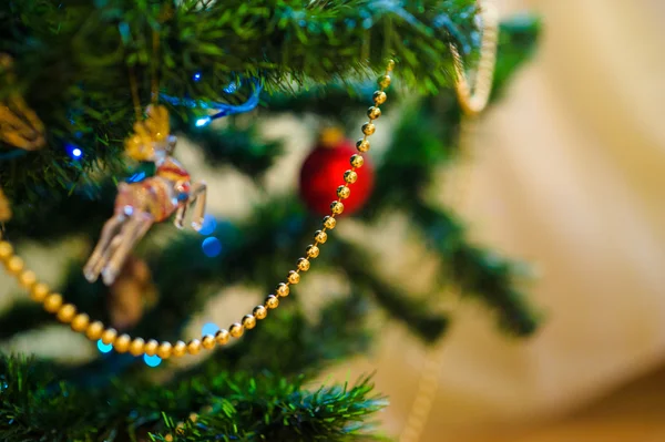 Christmas and New Year's toys on the Christmas tree — Stock Photo, Image