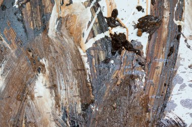 the wall is stained with brown and white paint